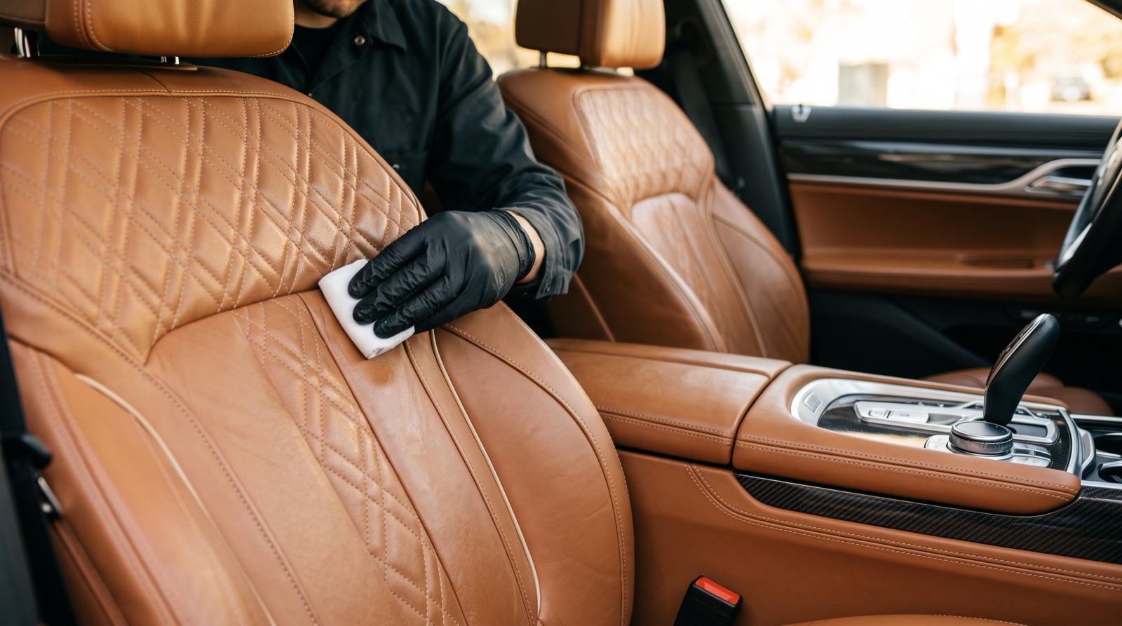 VIP Clinic technician restoring leather interior trim on a luxury vehicle